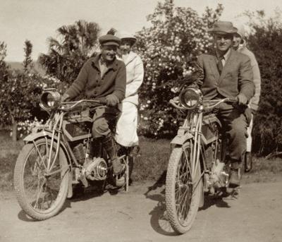People riding vintage motorcycles outdoors