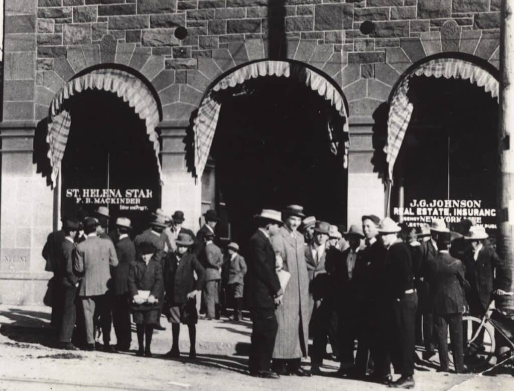Crowd gathers outside historic stone building offices