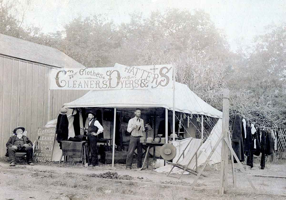 Vintage clothes cleaning and hat repair tent shop