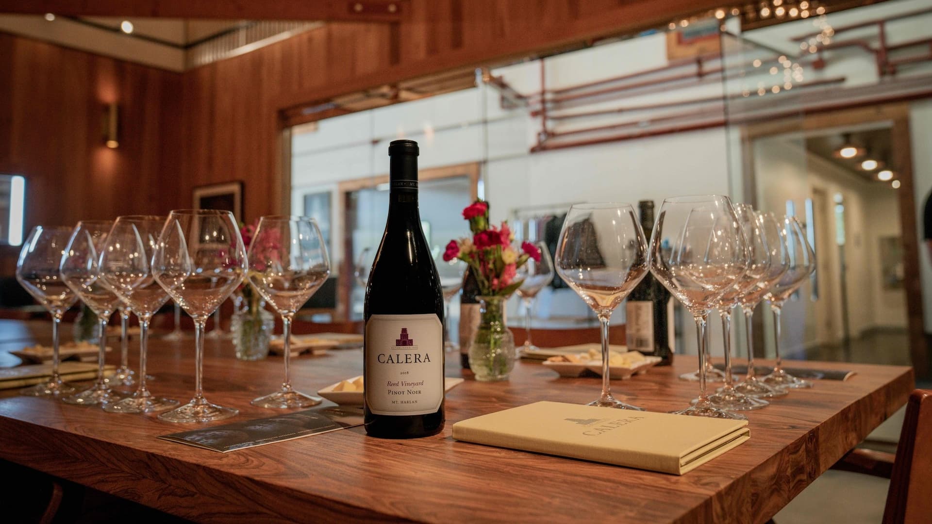Calera Pinot Noir wine with glasses on table.
