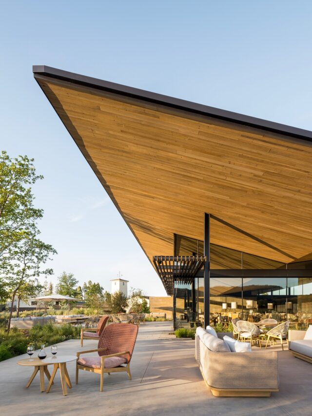 Modern building with dramatic angled wooden roof and patio