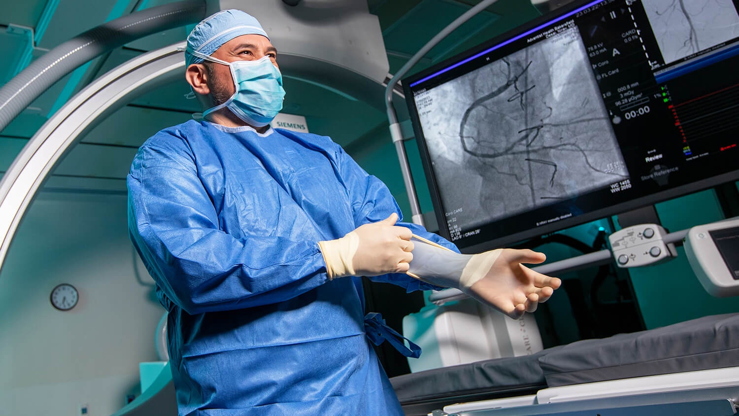 Surgeon preparing for procedure in operating room.