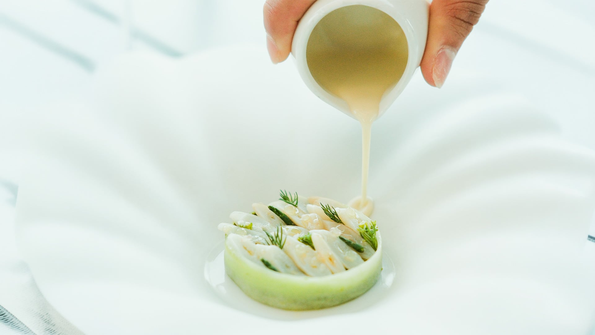 Creamy sauce poured over asparagus pasta salad