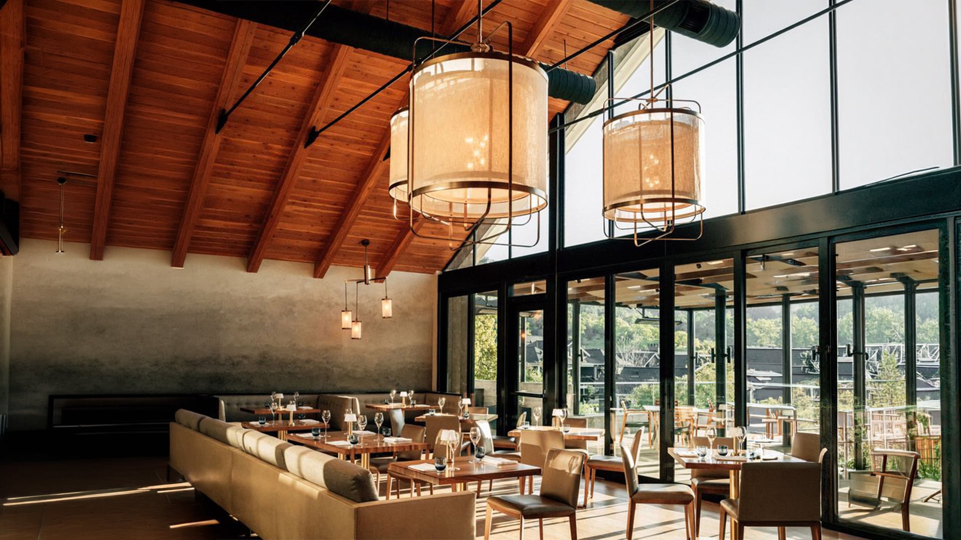 Modern restaurant interior with wooden ceiling and large windows