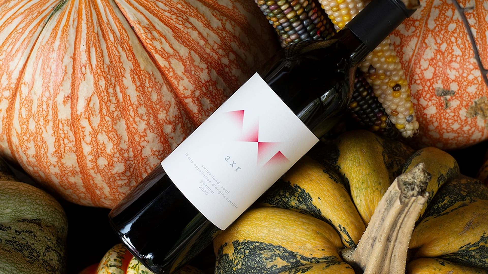 Wine bottle with autumn pumpkins and corn