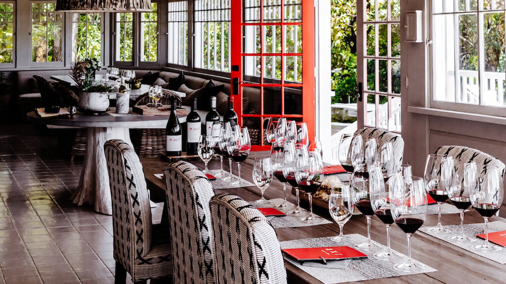 Elegant dining table with wine glasses and bottles.