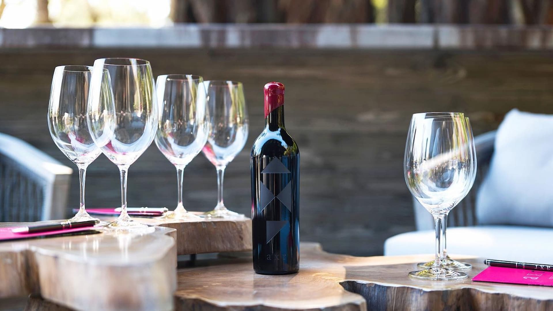 Wine bottle with empty glasses on wooden table