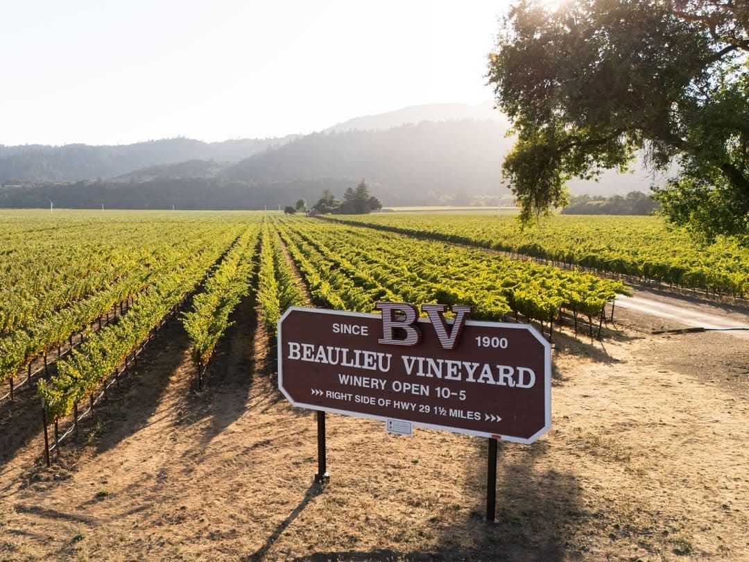 Beaulieu Vineyard sign in scenic vineyard landscape.