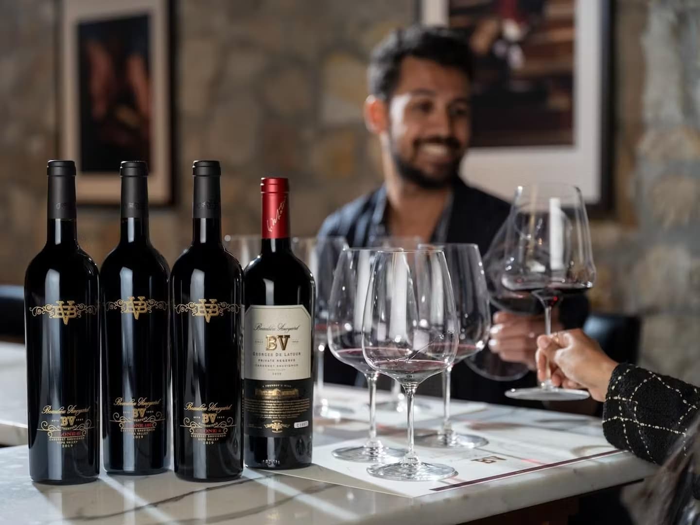 Wine tasting with four bottles and glasses.