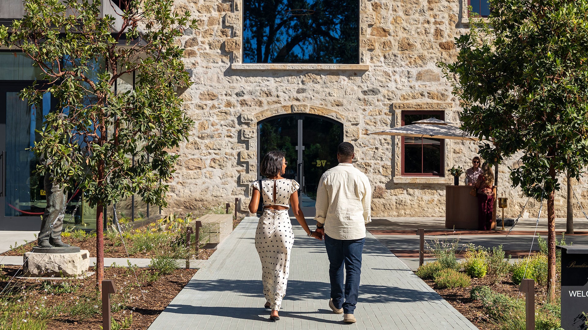 Couple walks toward entrance of historic stone building