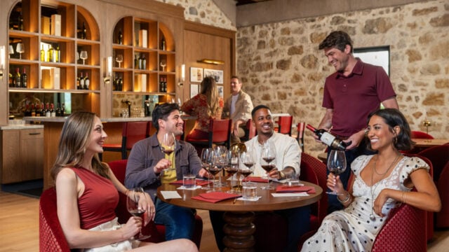 Friends enjoying wine tasting at a rustic restaurant
