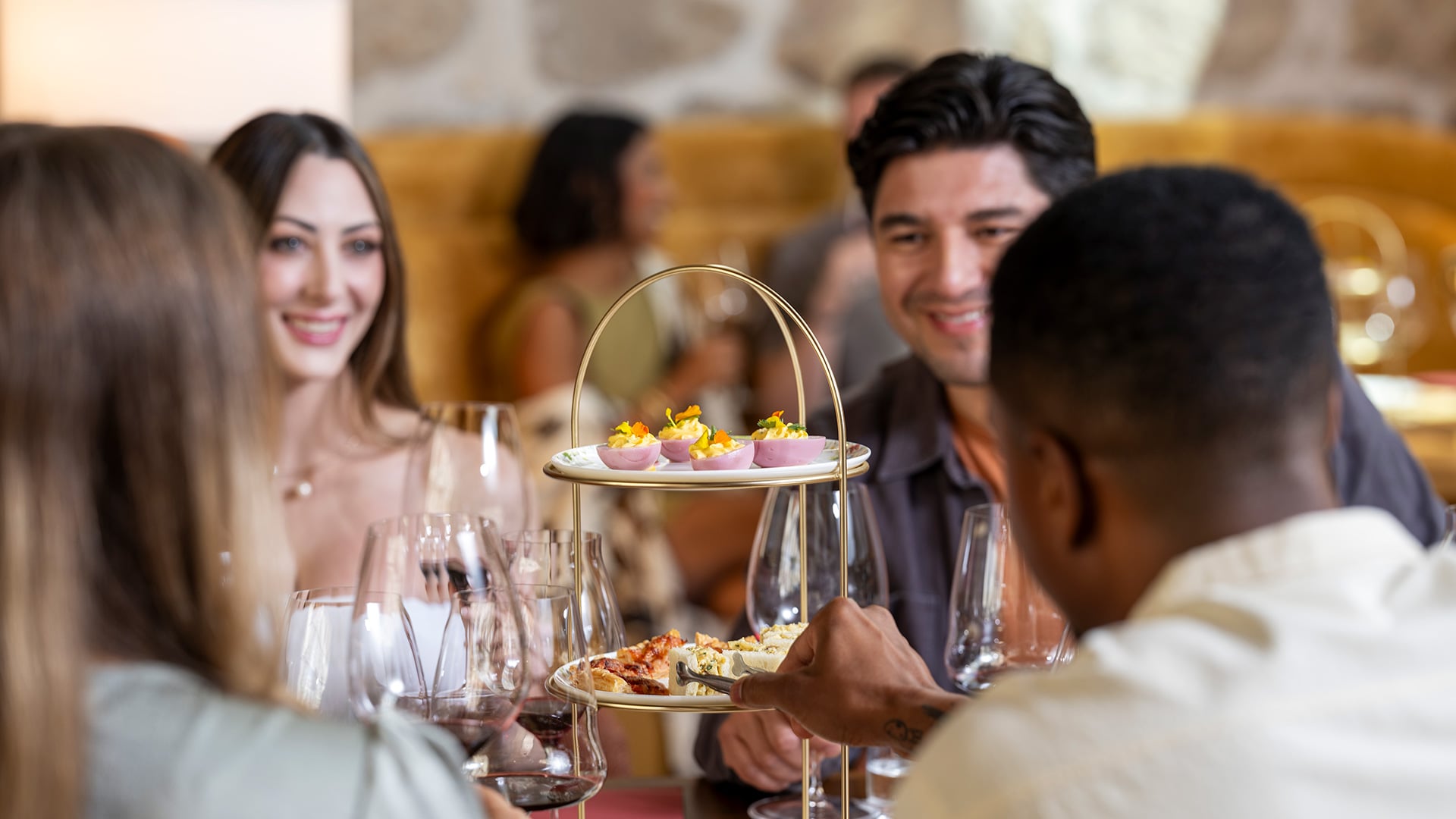 Friends sharing appetizers and wine at a restaurant