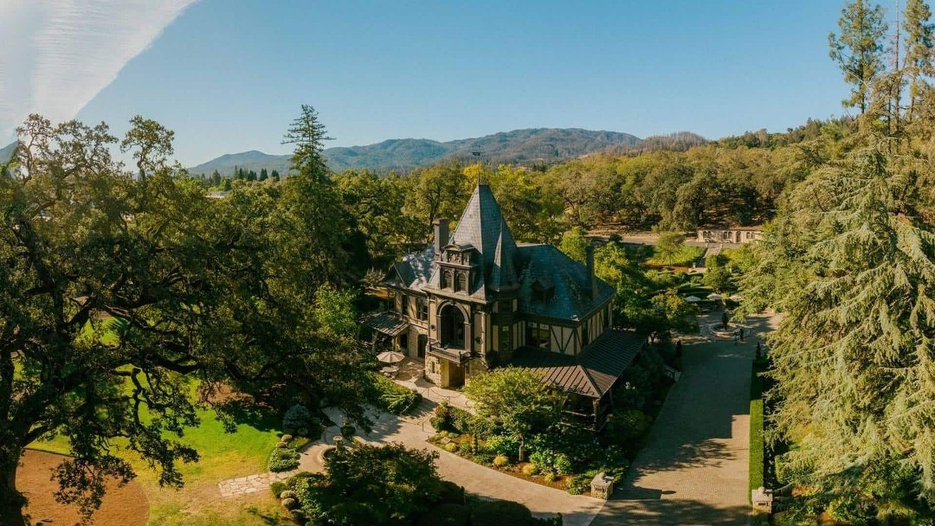 Historic mansion surrounded by lush trees and gardens