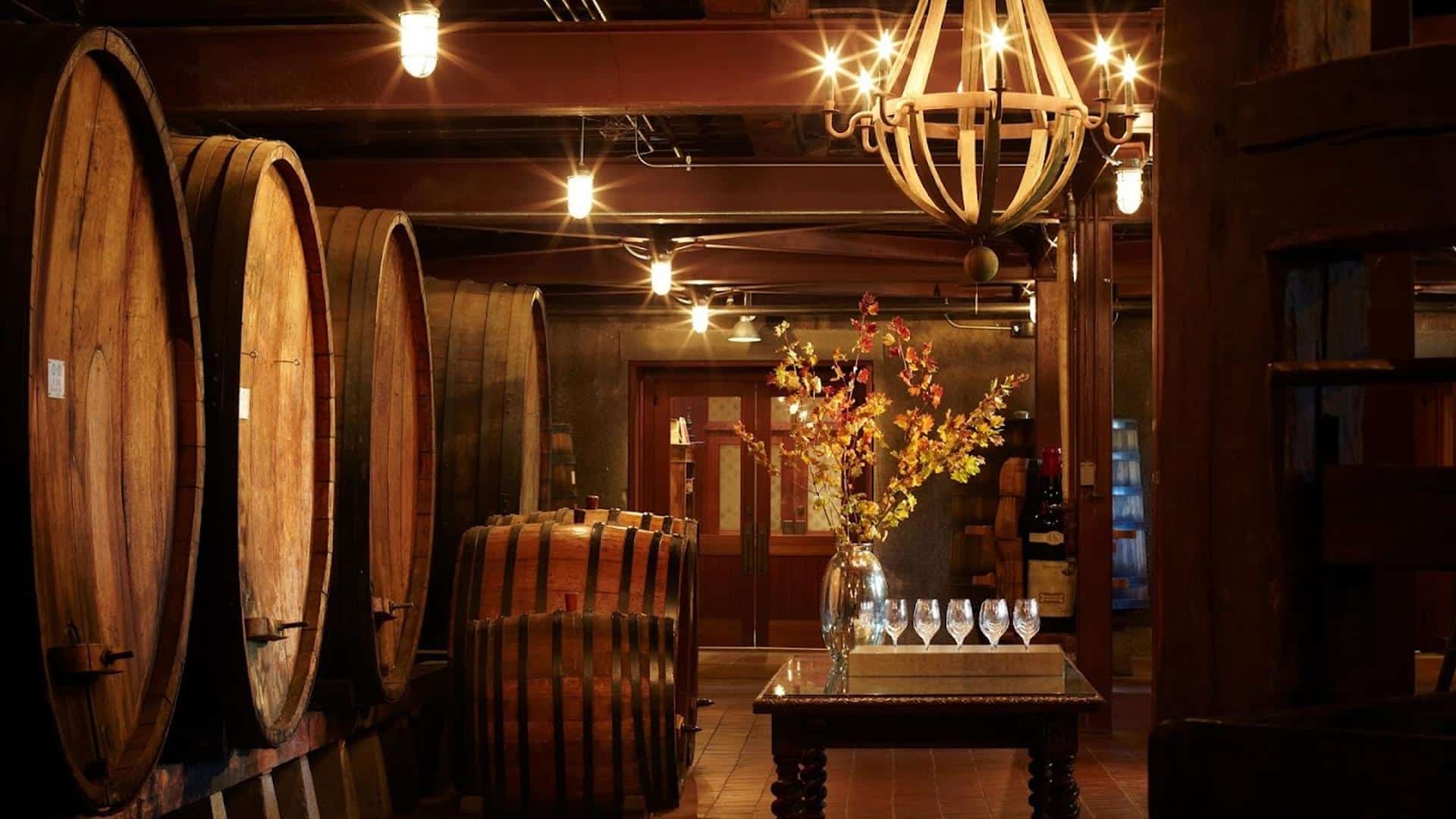 Wine cellar with barrels and decorated table.