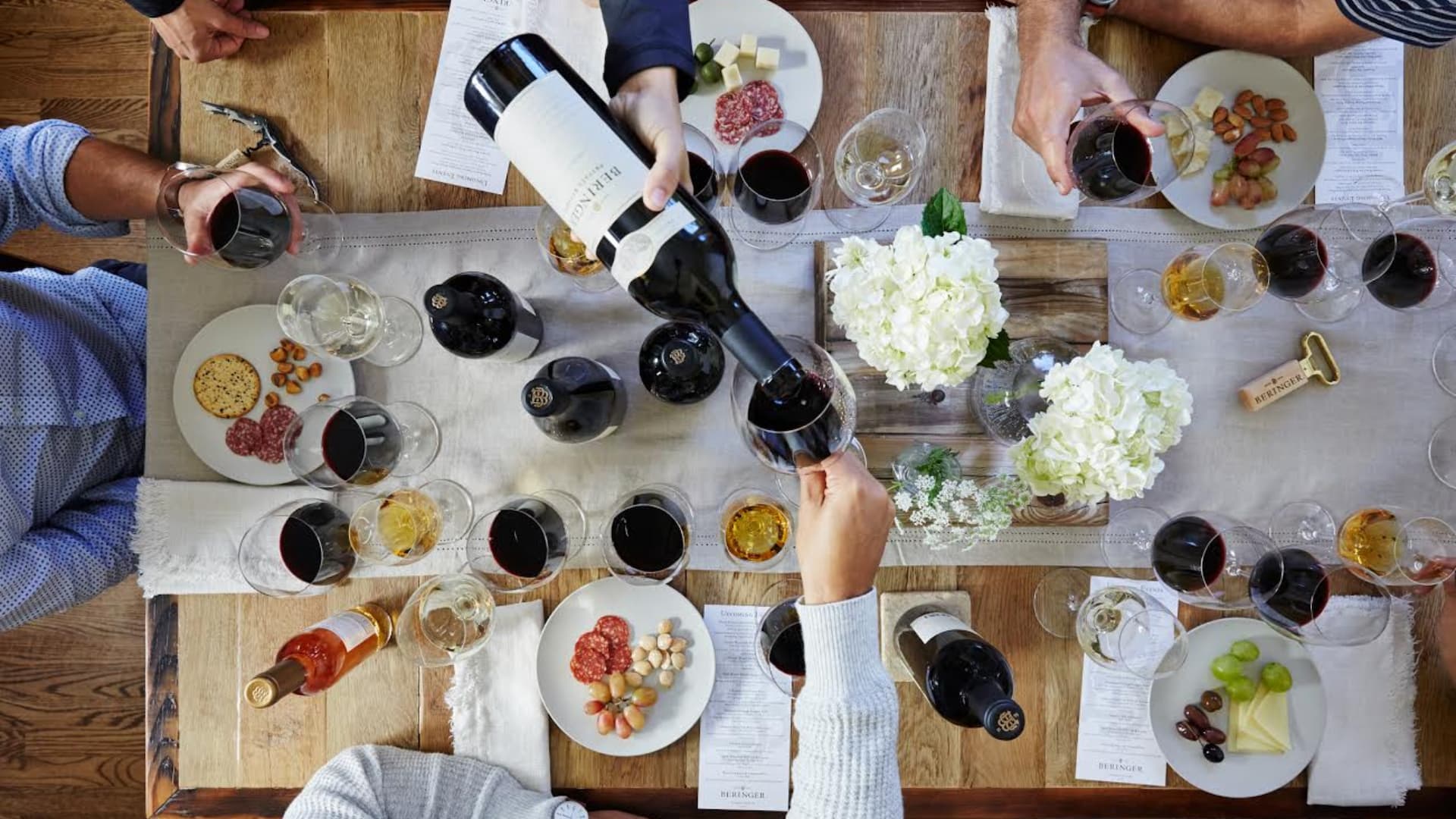 Wine tasting with friends around table.