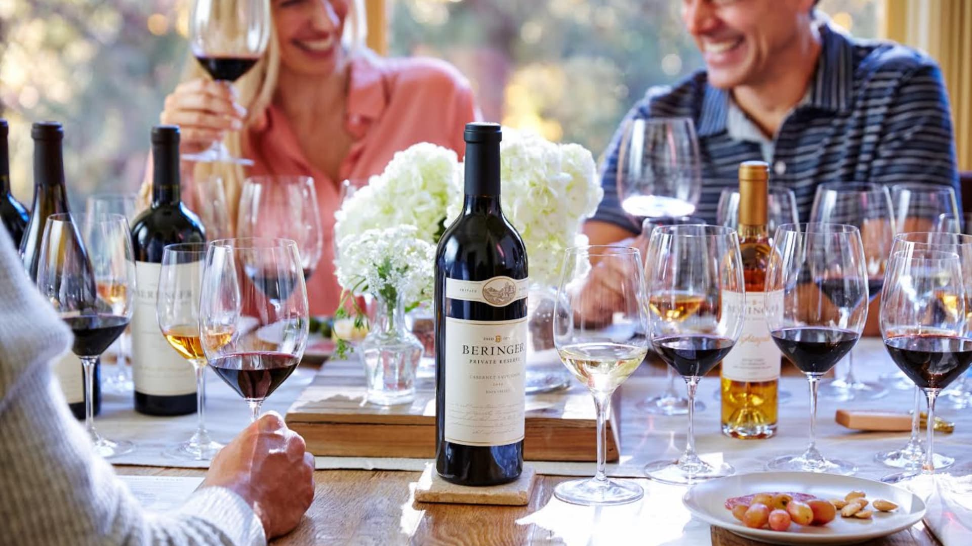 People enjoying wine at a dinner gathering.
