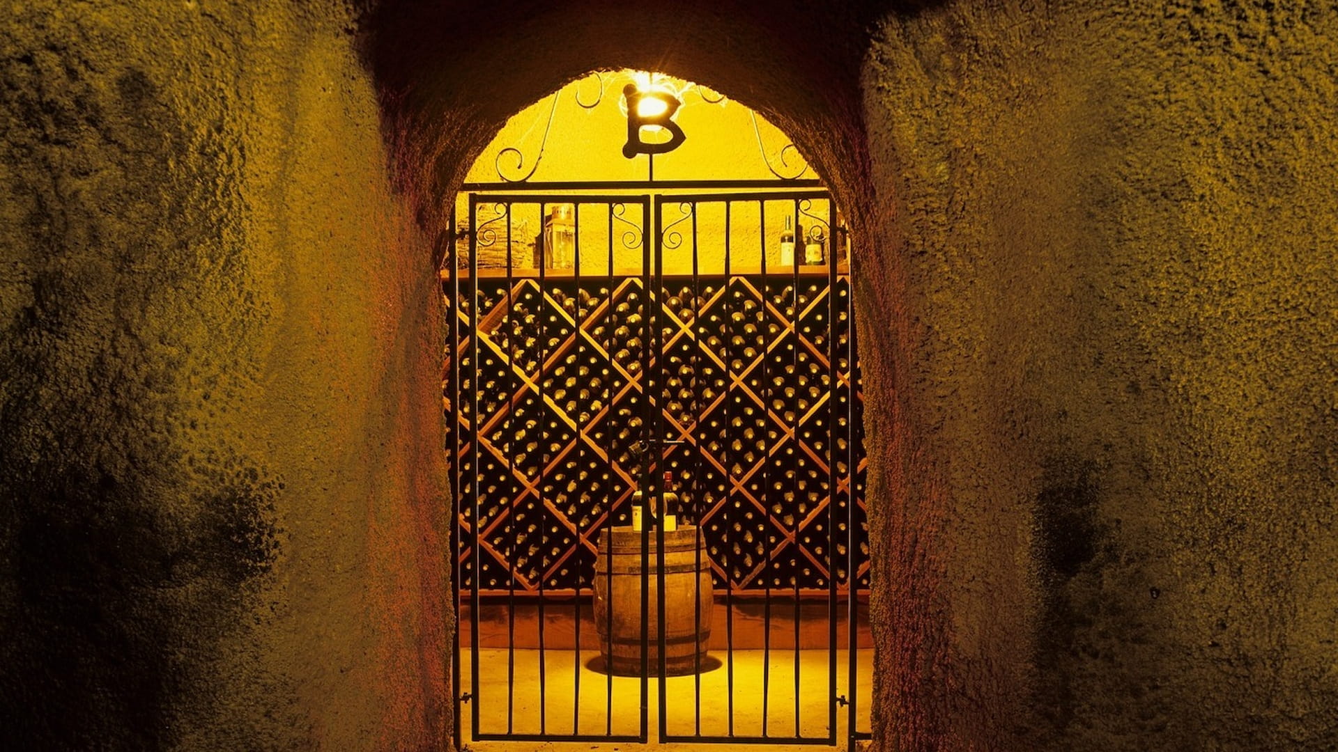 Entrance to dimly lit wine cellar with bottles.