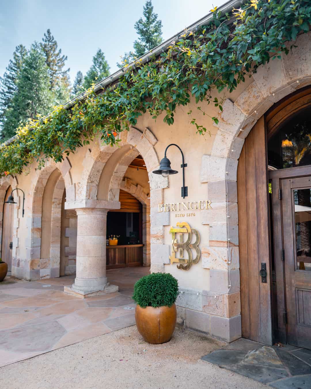 Stone entrance with greenery and arched doorways.