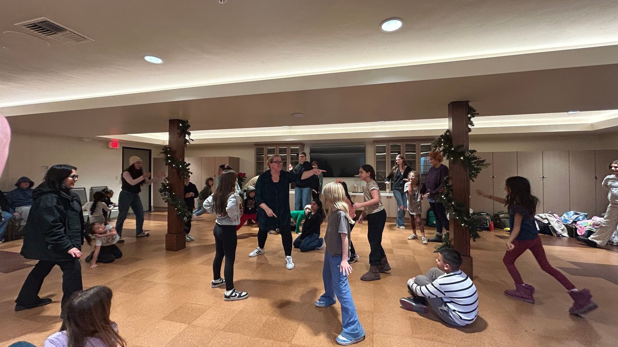Children and adults playing indoors together
