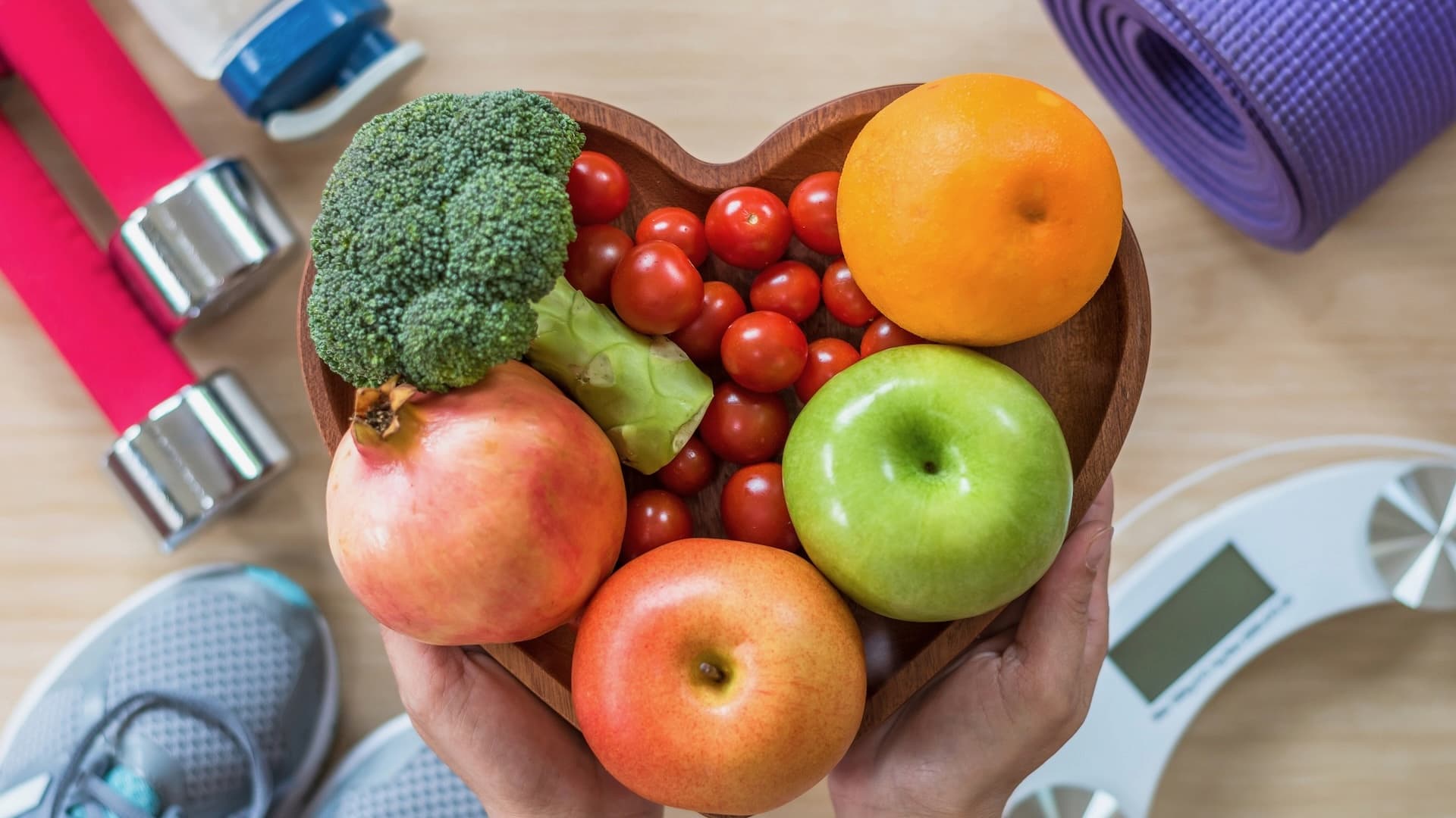 Healthy fruits and vegetables with fitness equipment