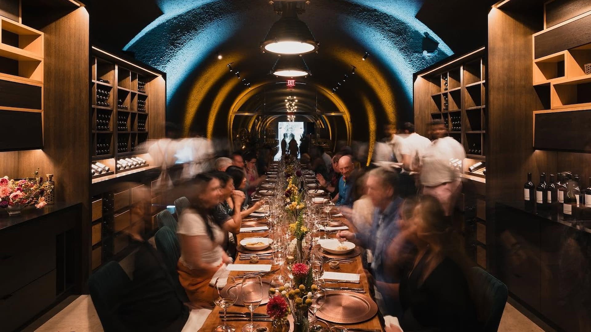 Long dinner table in vaulted wine cellar restaurant