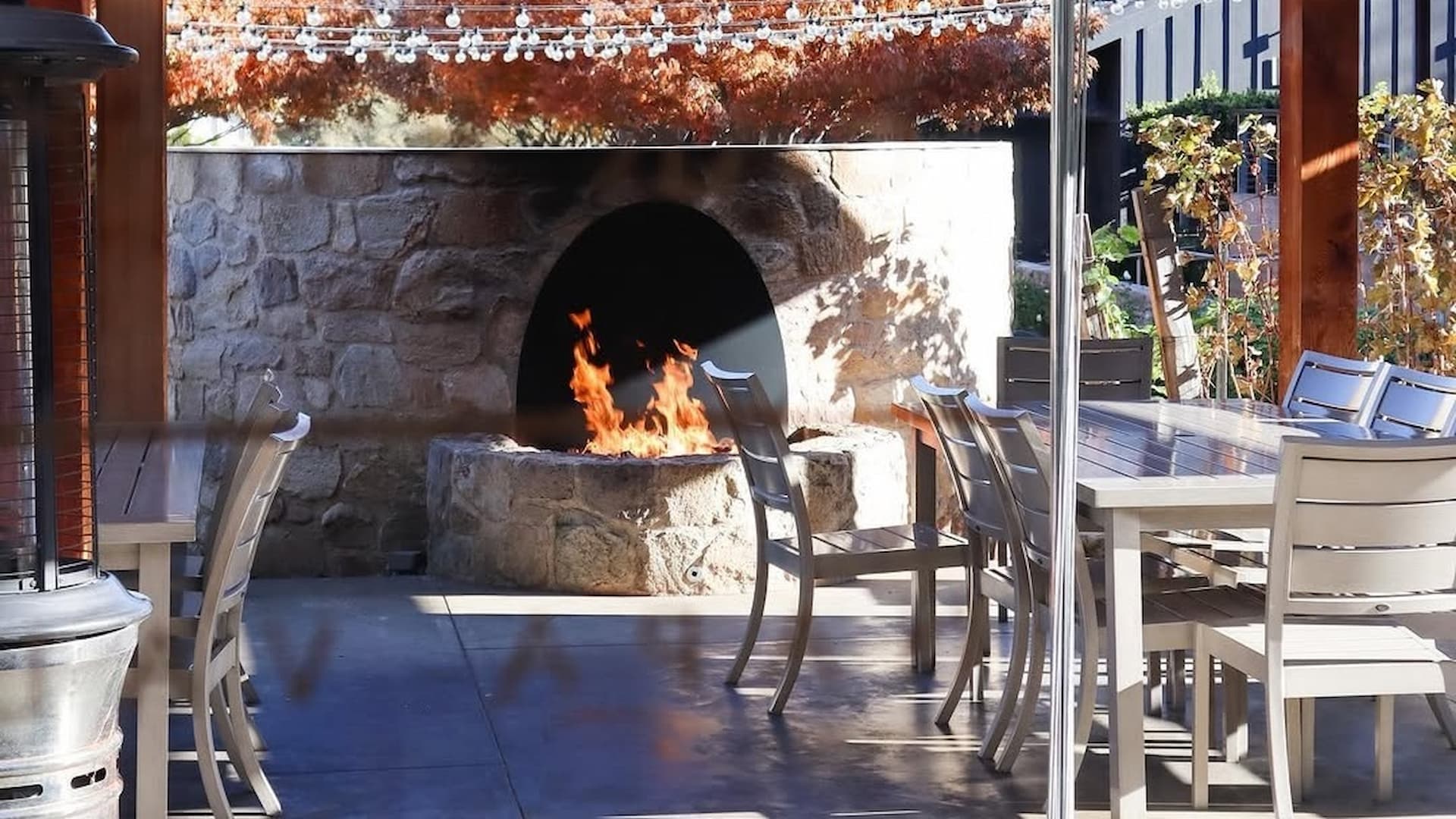 Cozy patio with fireplace and dining table.