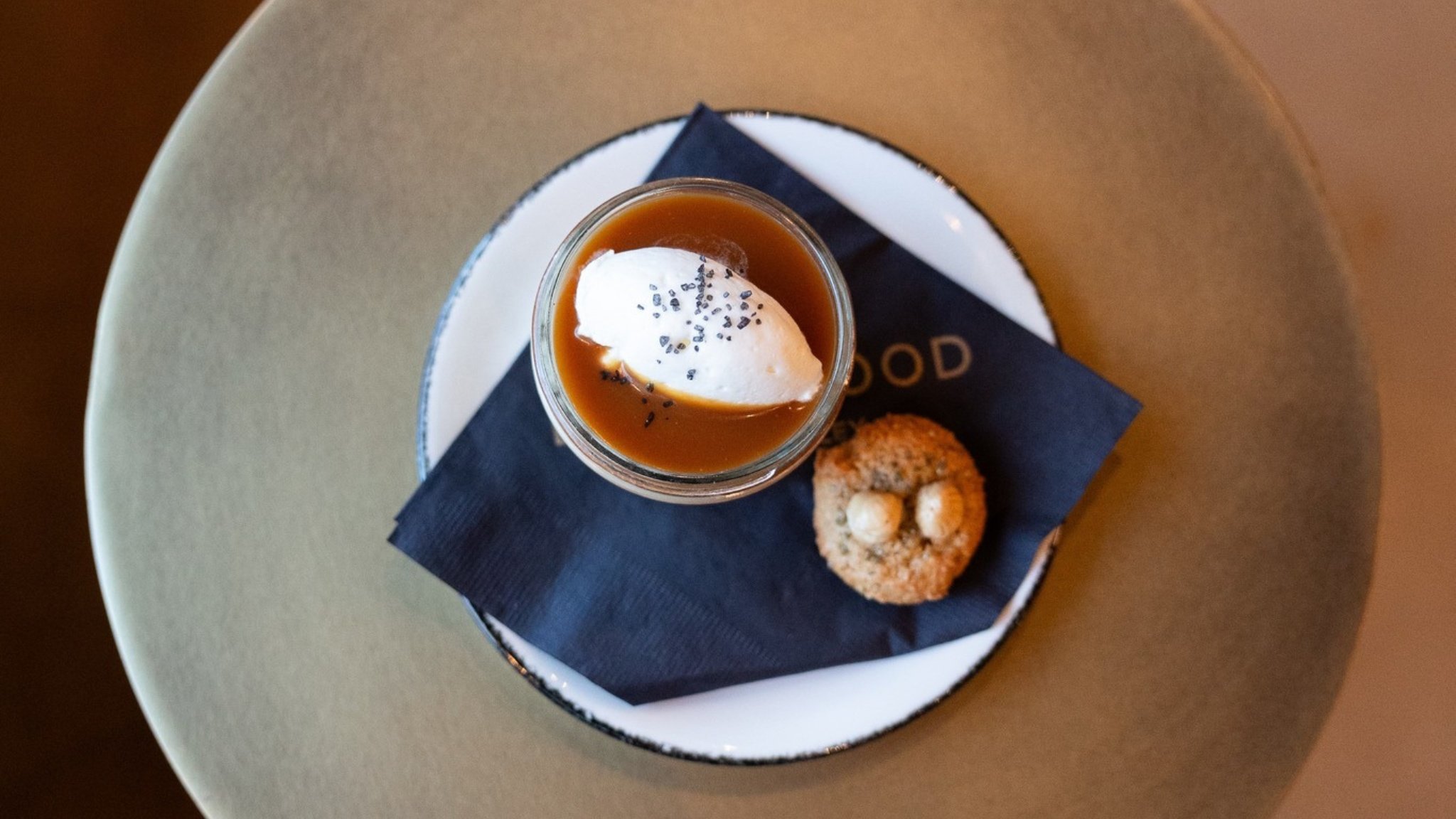 Dessert with whipped cream and cookie on plate