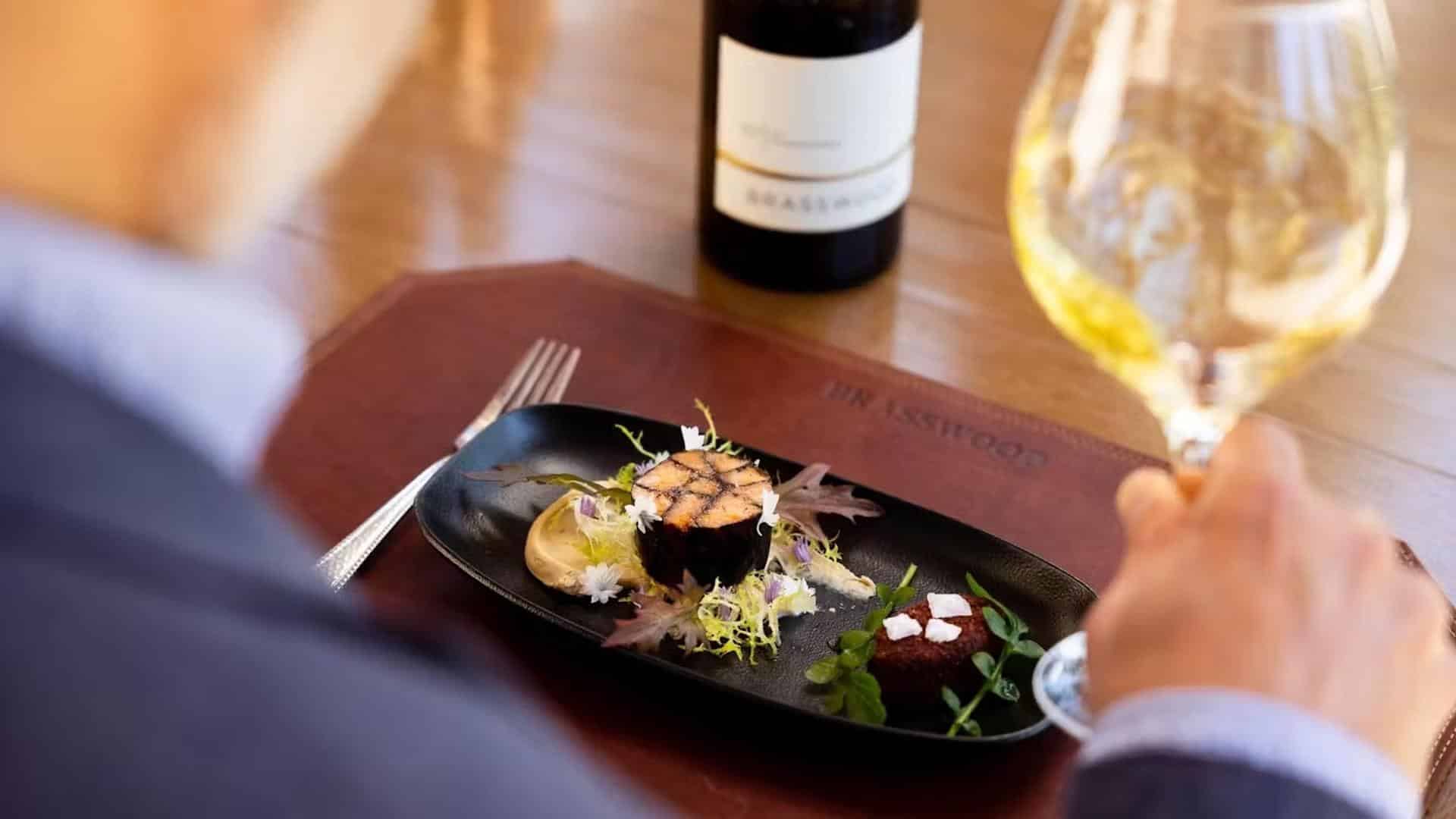 Gourmet dish with wine glass and bottle