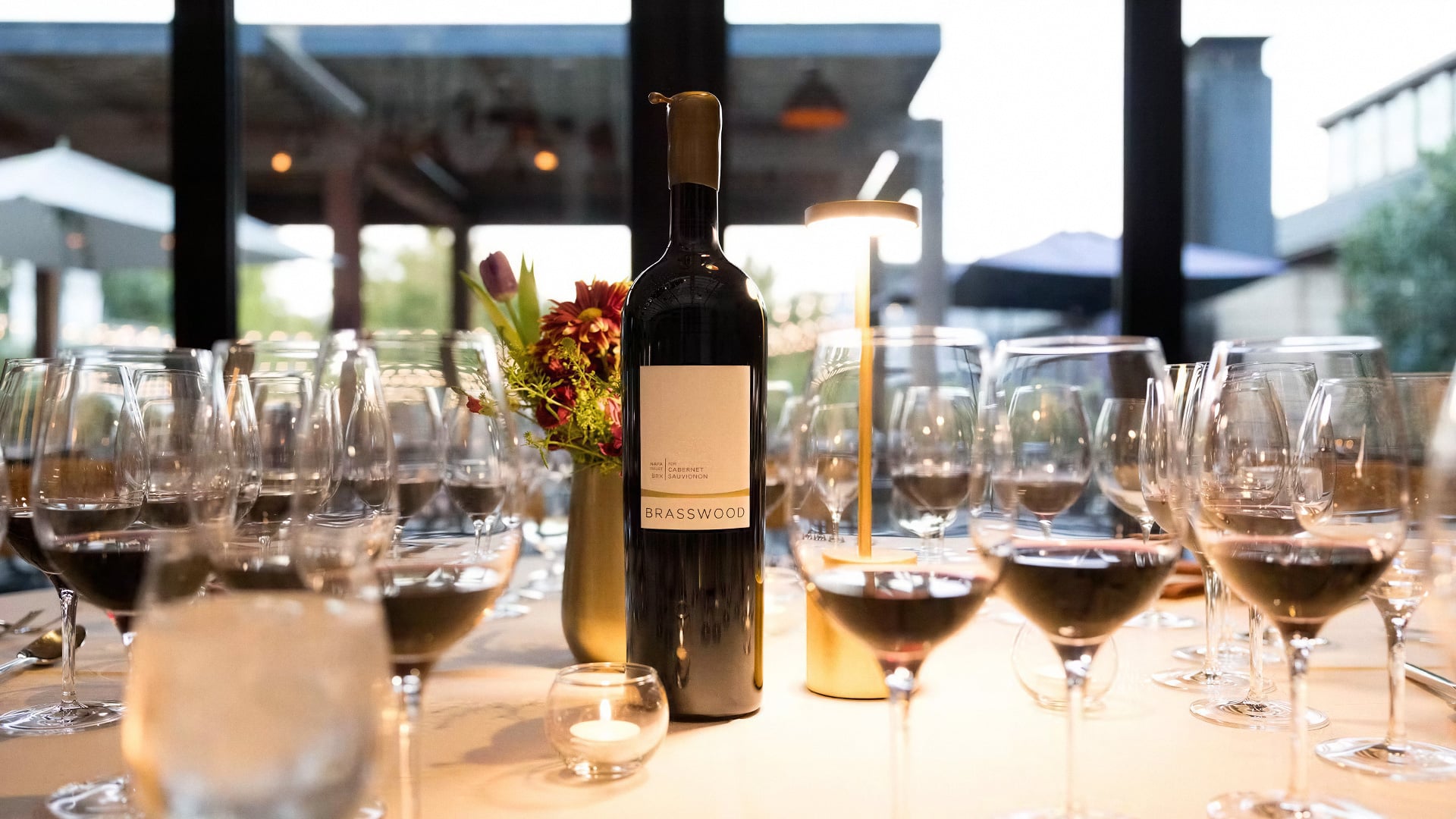 Brasswood Cabernet bottle among wine glasses on dinner table