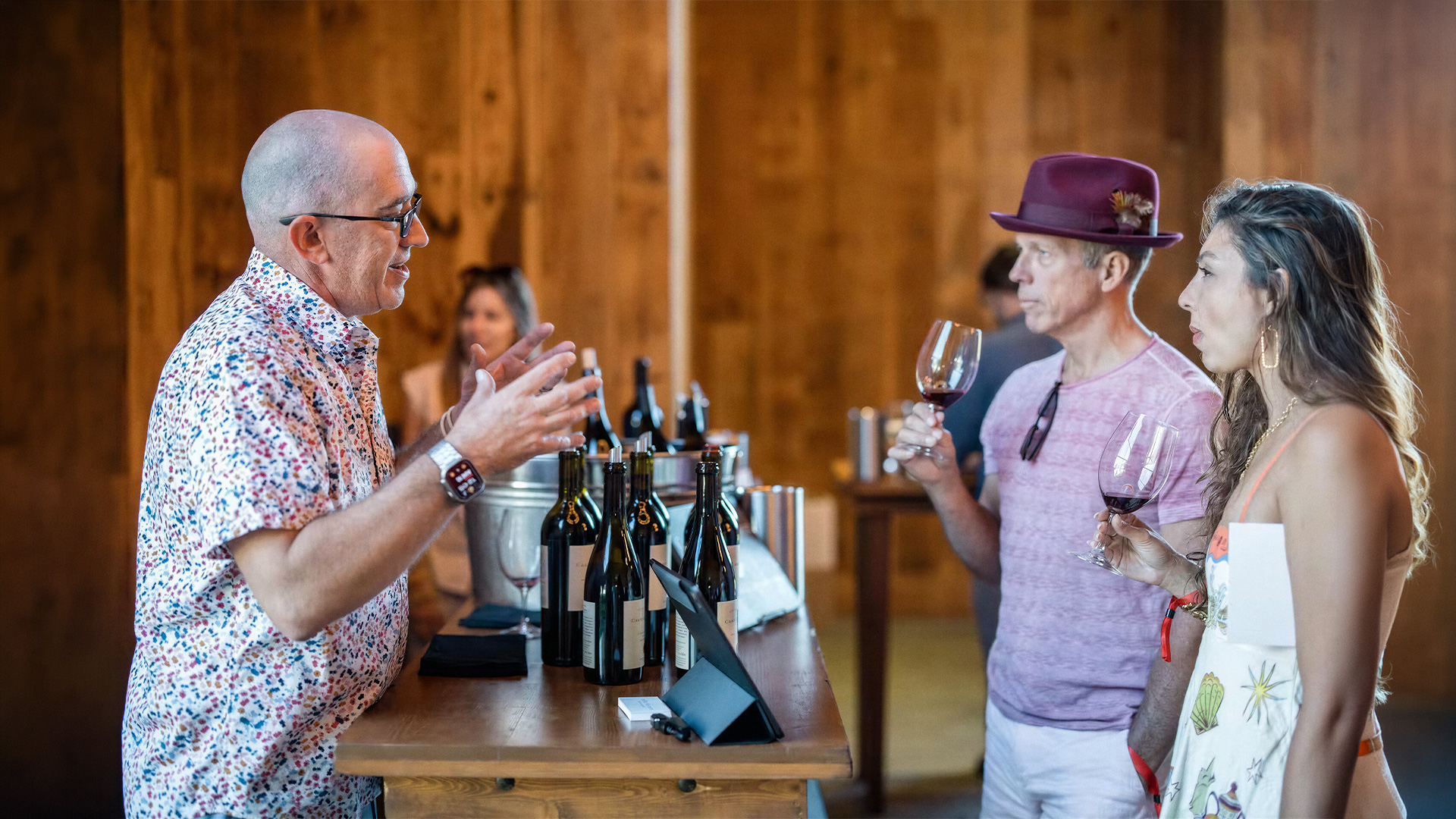 Guests sample wine during a winery tasting