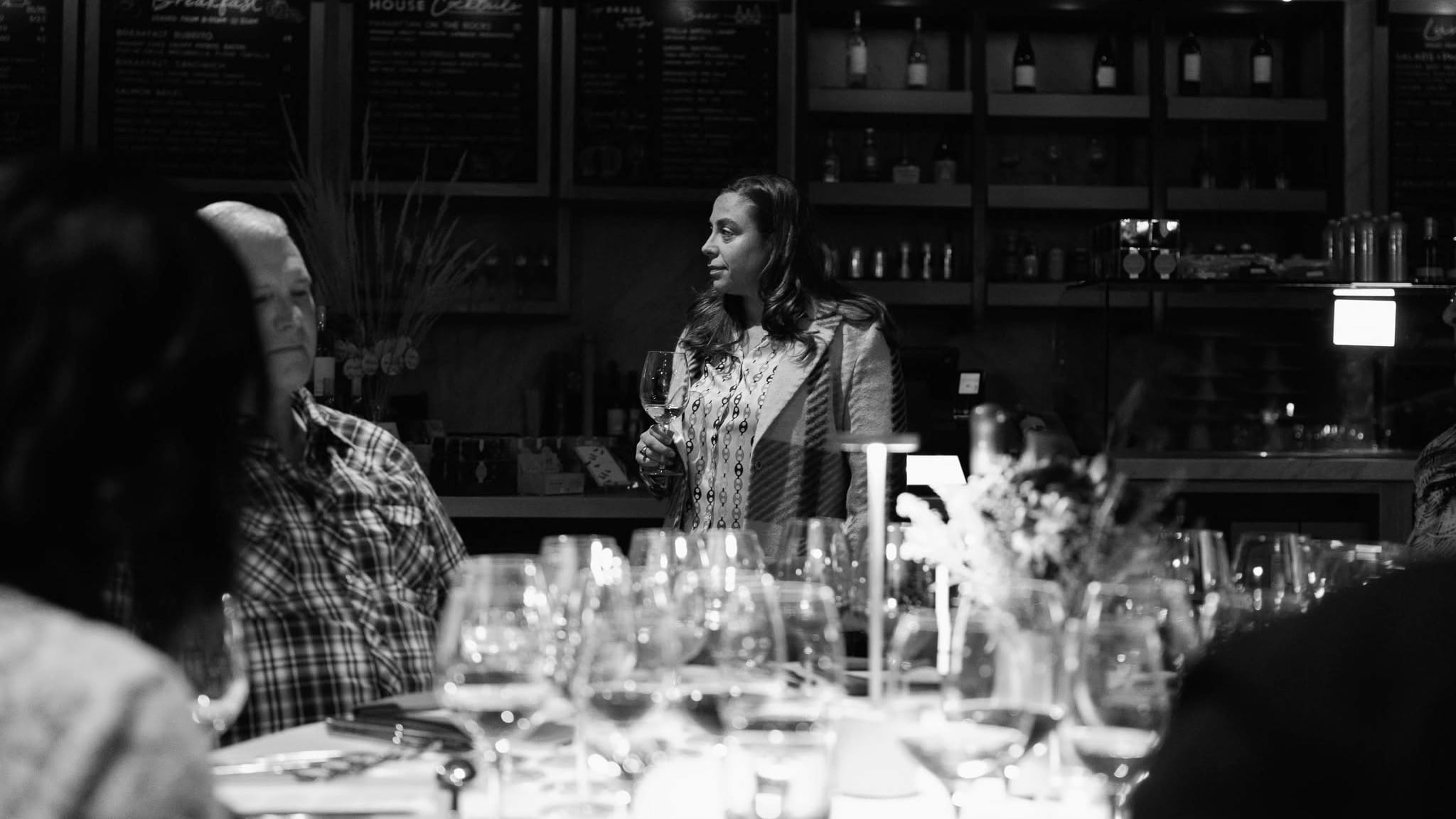 Woman holding wine glass at tasting event