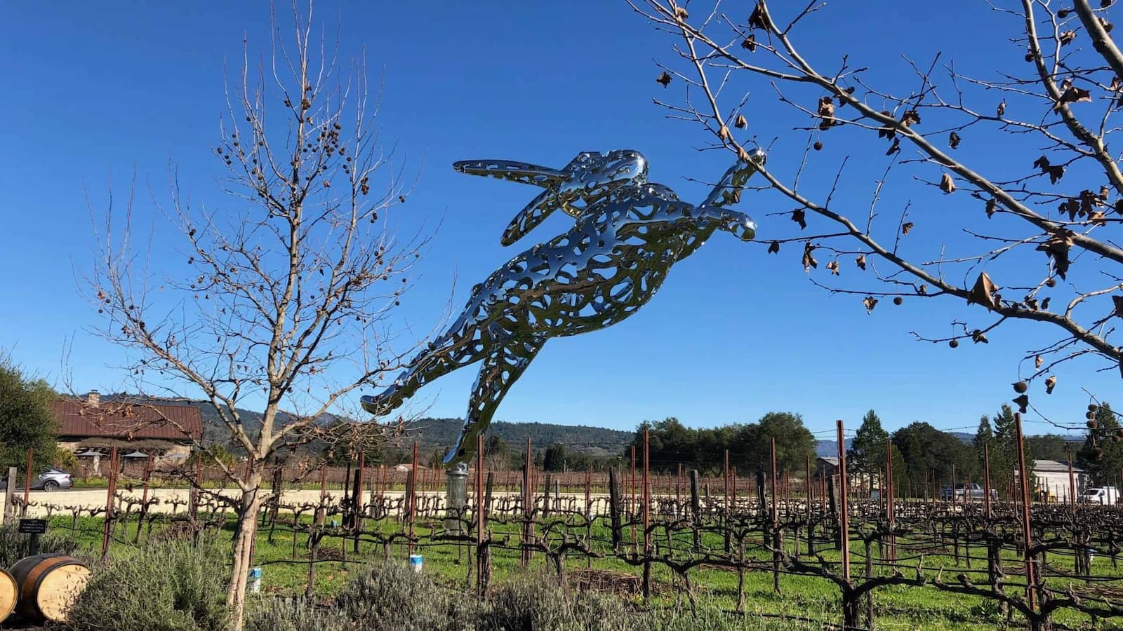 Metal rabbit sculpture in a vineyard field