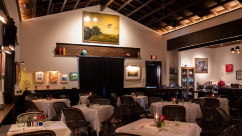 Cozy restaurant interior with white tablecloth tables