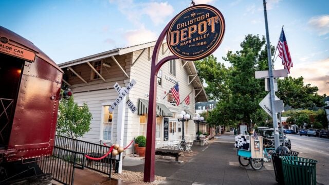 Calistoga Depot with railroad crossing sign and flags.