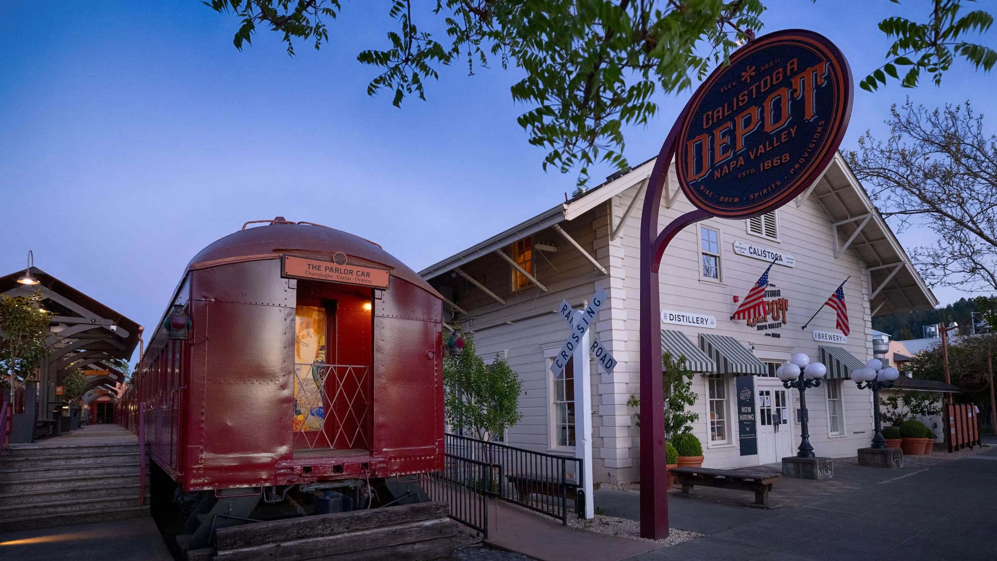 Historic train depot with red train car.