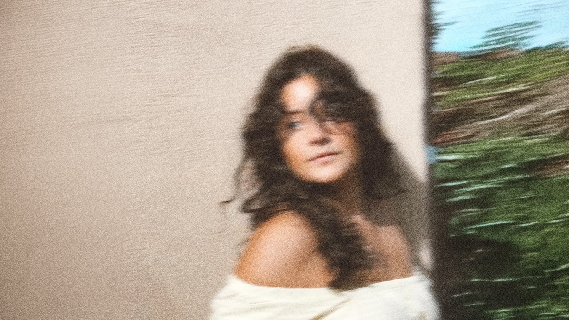 Blurred portrait of woman with curly hair