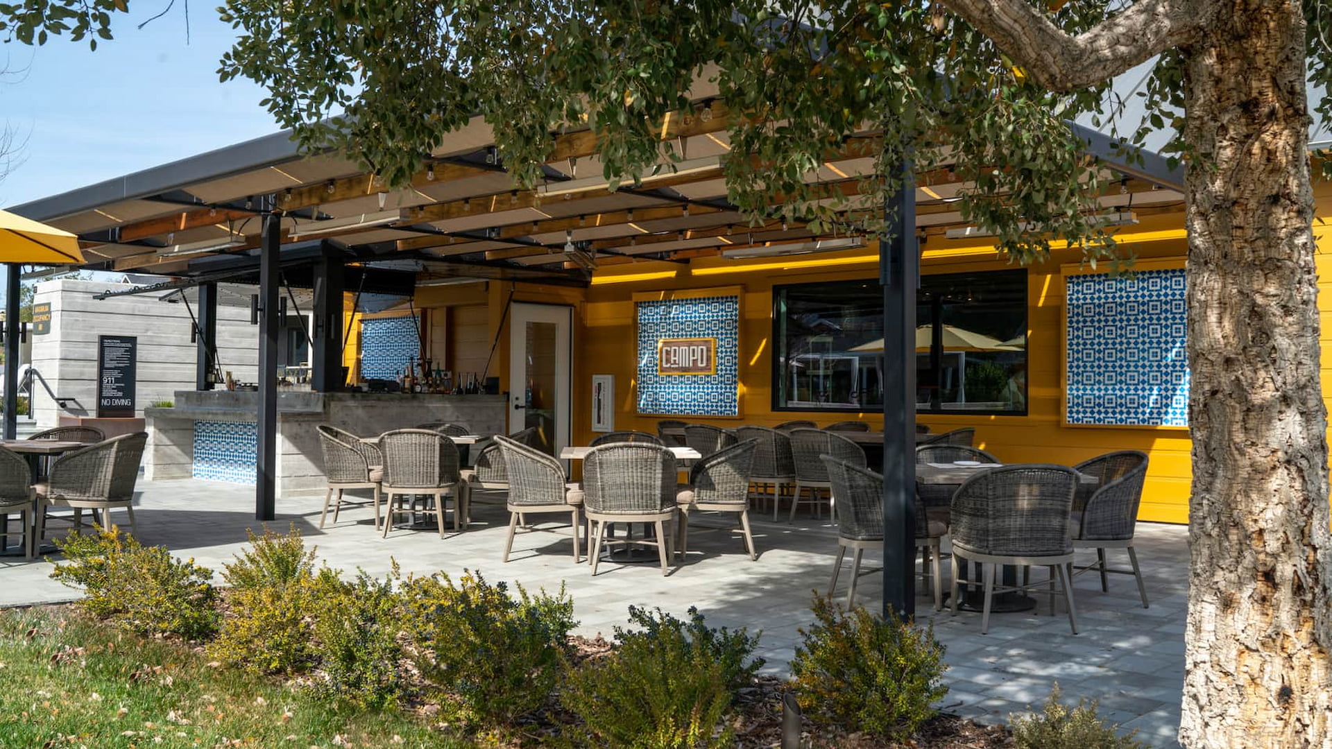 Outdoor restaurant seating with yellow and blue decor
