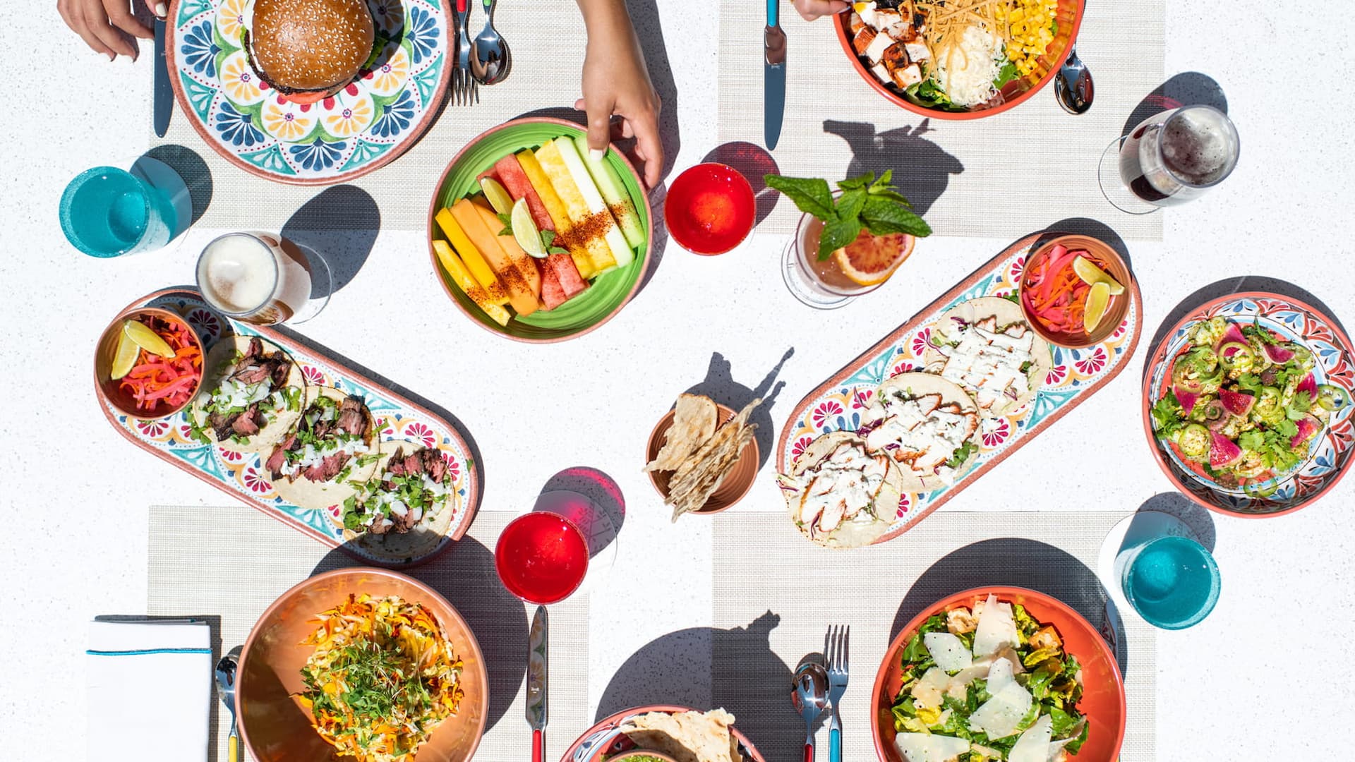 Colorful Mexican dishes arranged on table.