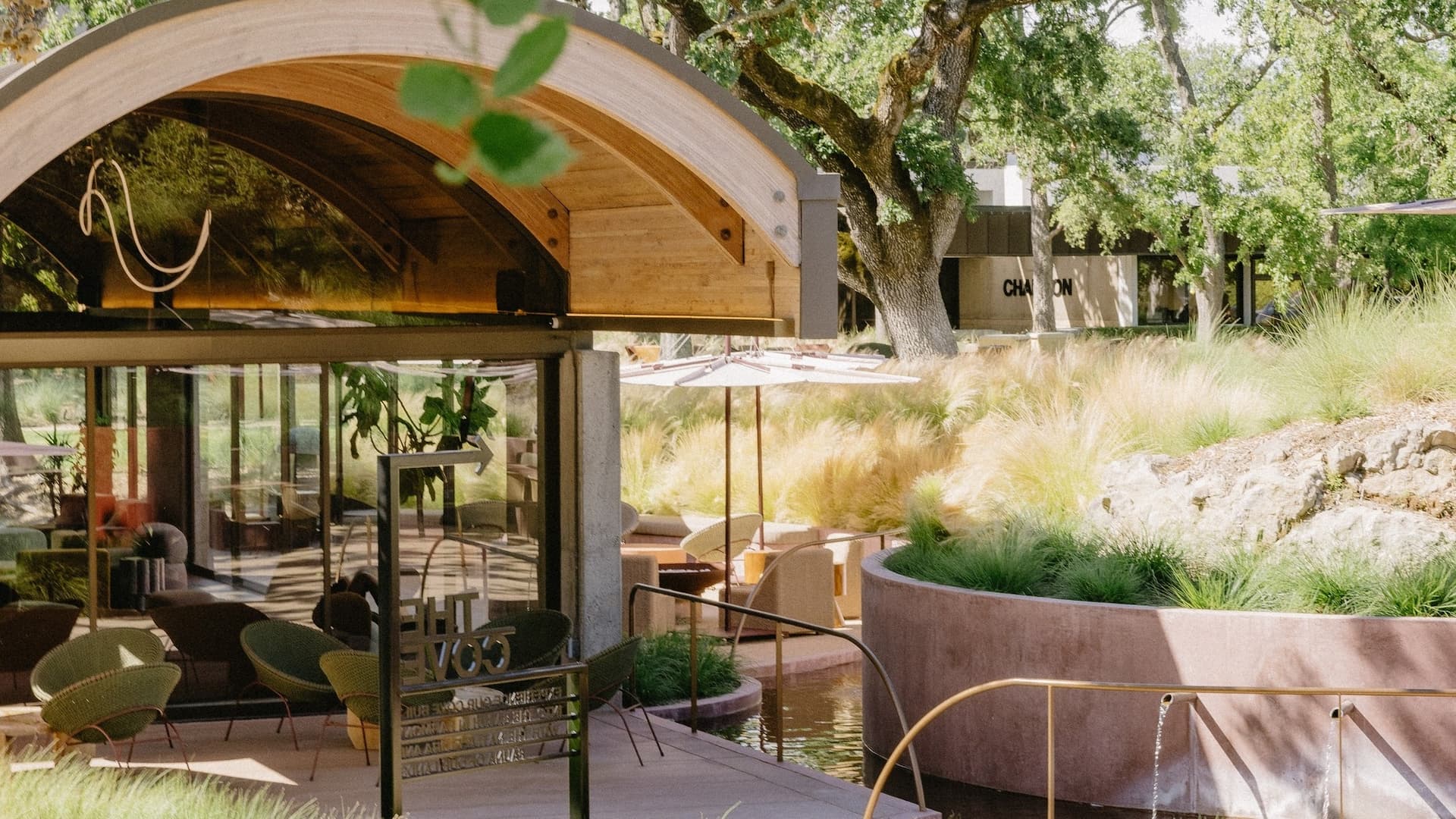 Elegant outdoor patio with modern architecture and greenery.