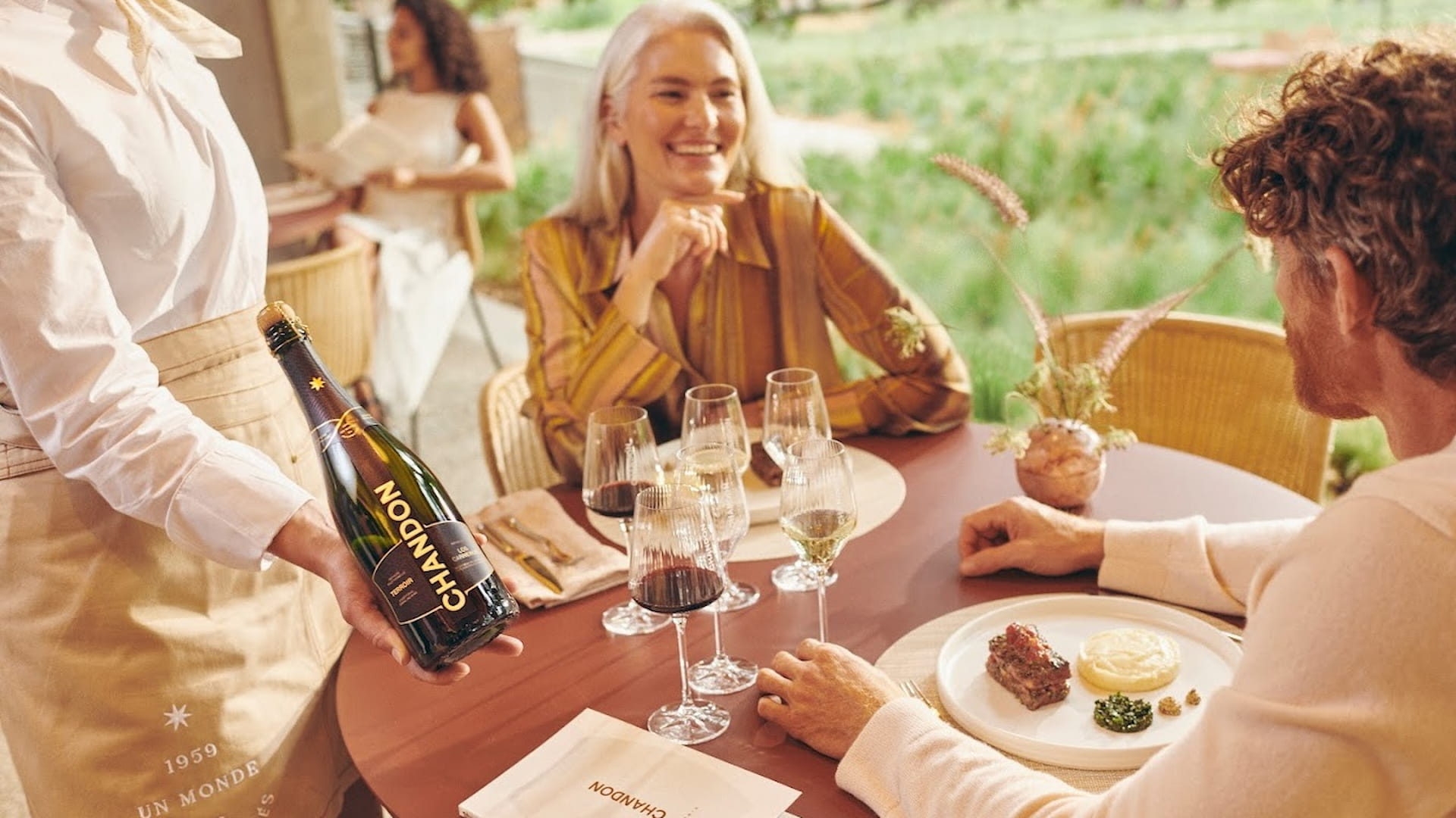 Dining with wine and gourmet food outdoors.