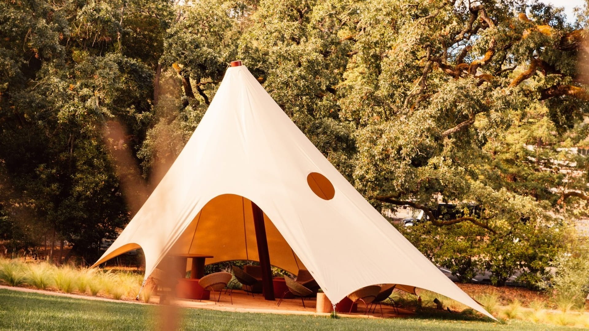 Elegant tent in a lush garden setting.