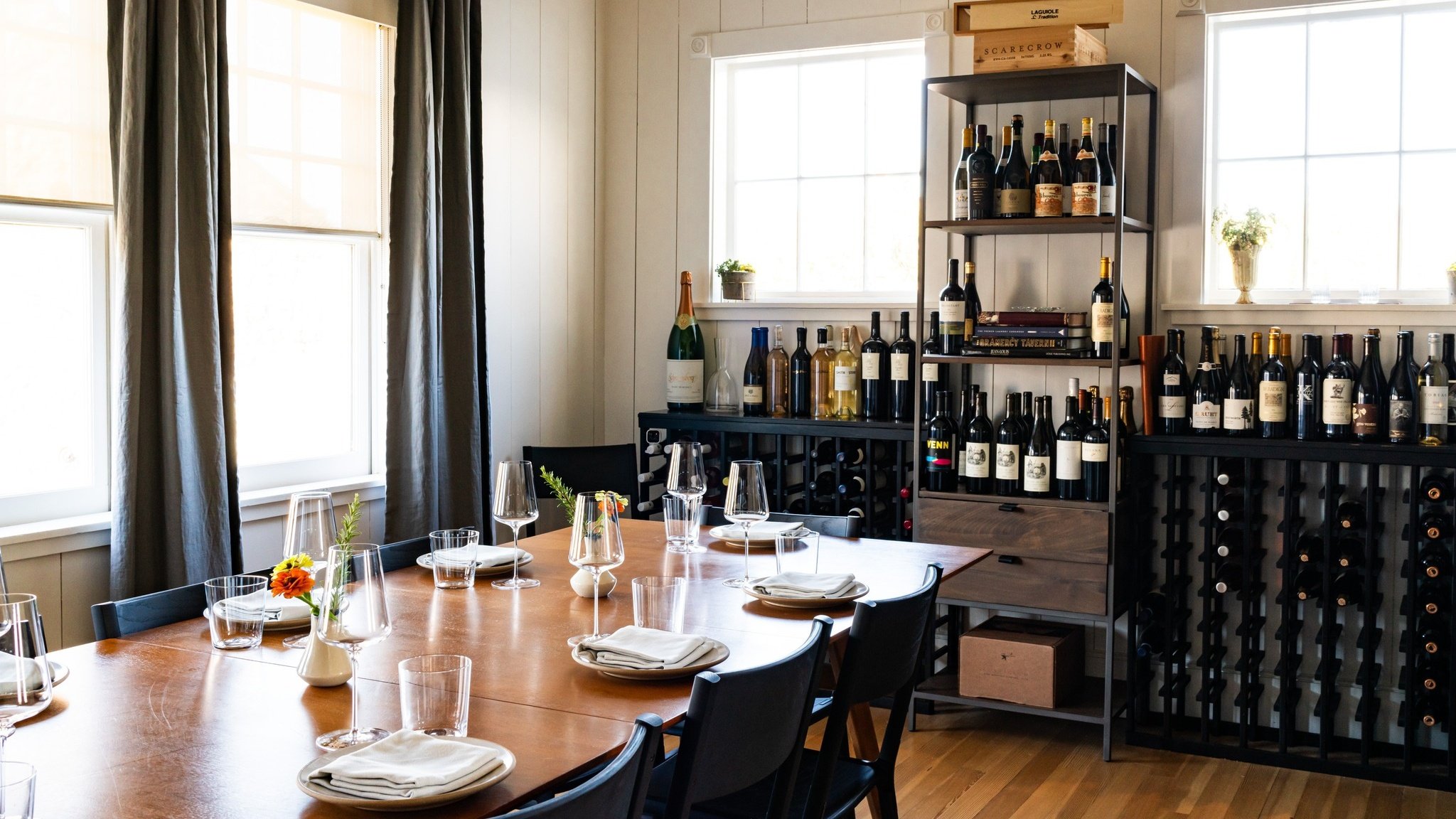 Dining room with wine shelves and set table.
