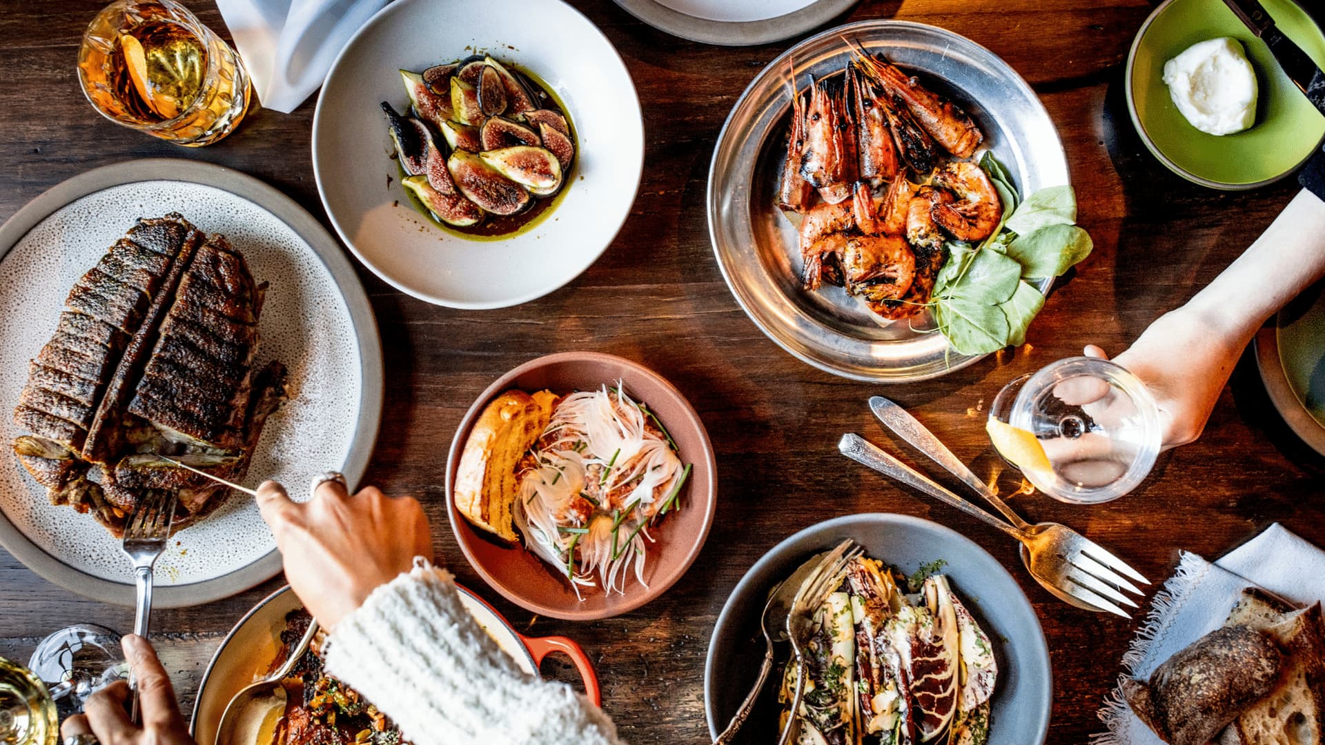Gourmet dishes on a wooden table, dining scene.