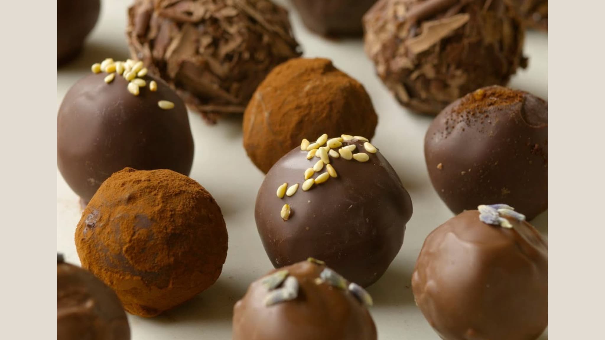 Assorted chocolate truffles with cocoa and nut toppings
