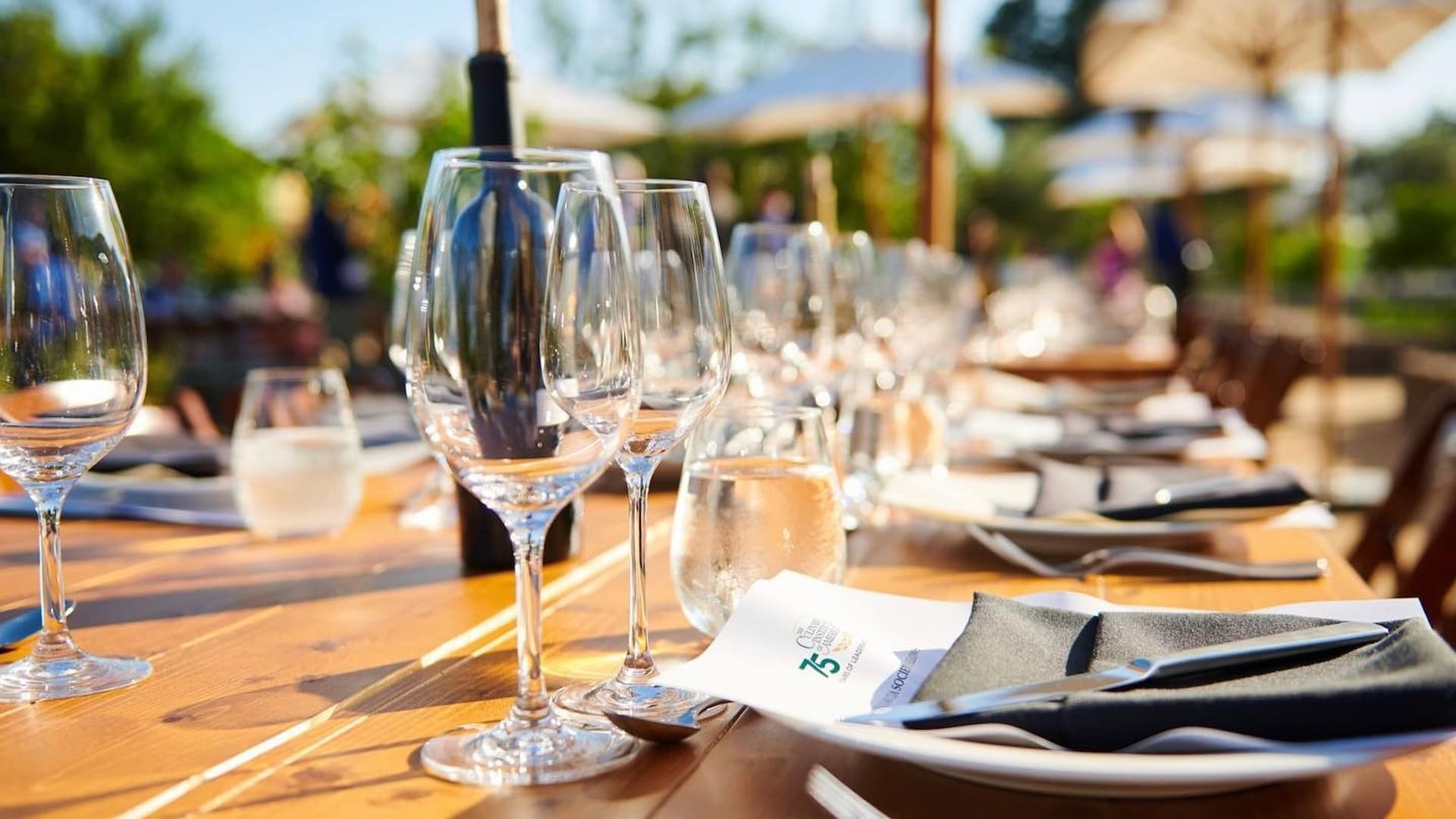 Outdoor dining table set with wine glasses