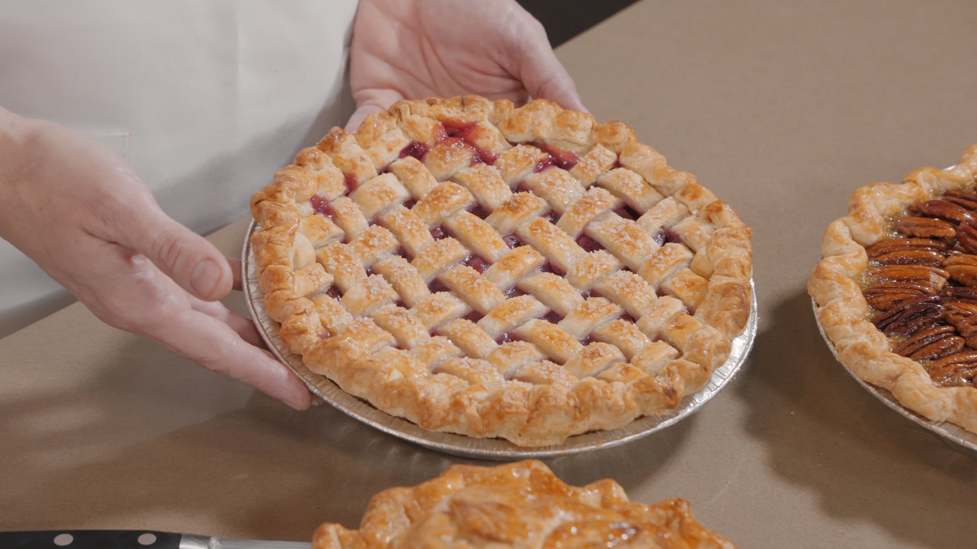 Freshly baked lattice top cherry pie on display.