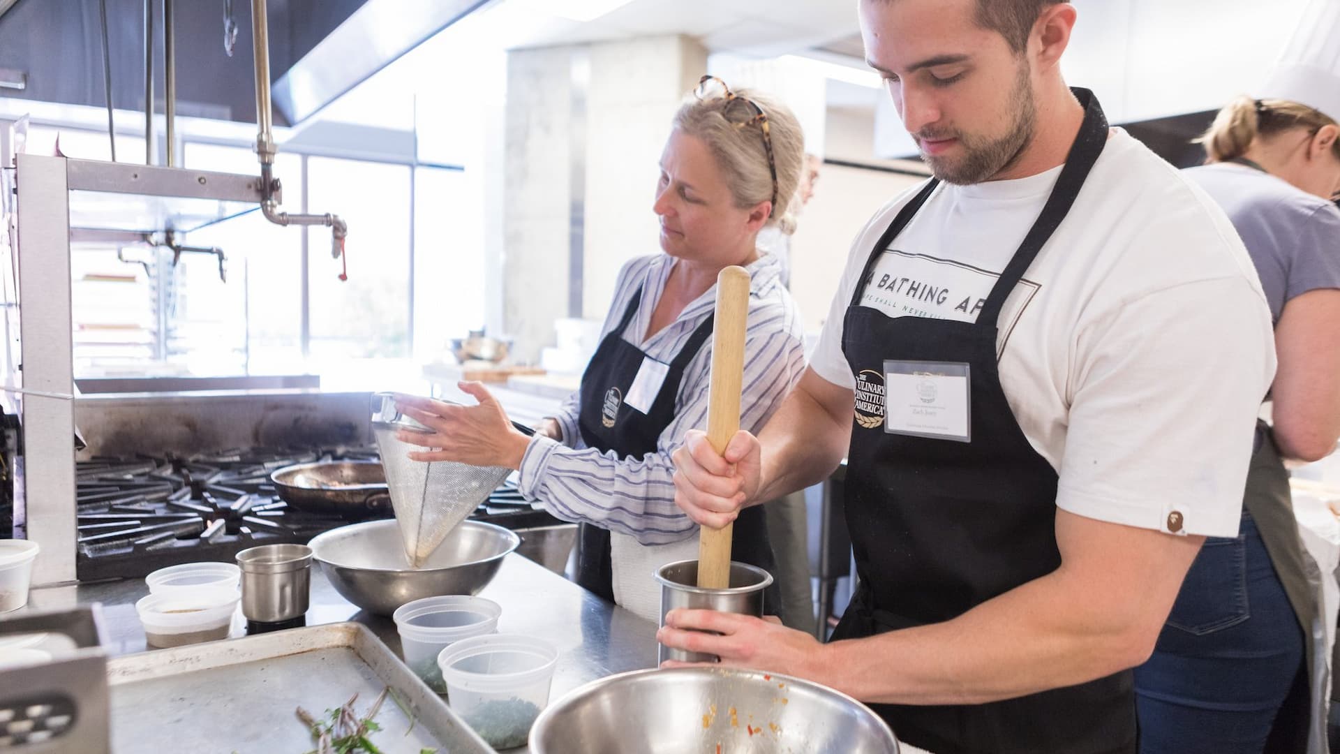 Chefs preparing ingredients in a professional kitchen