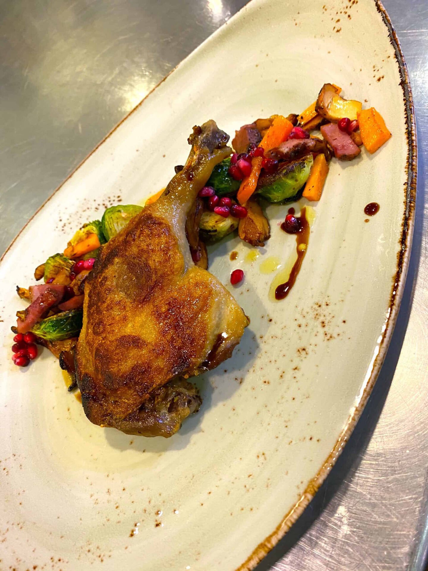 Gourmet roasted chicken leg with vegetables.