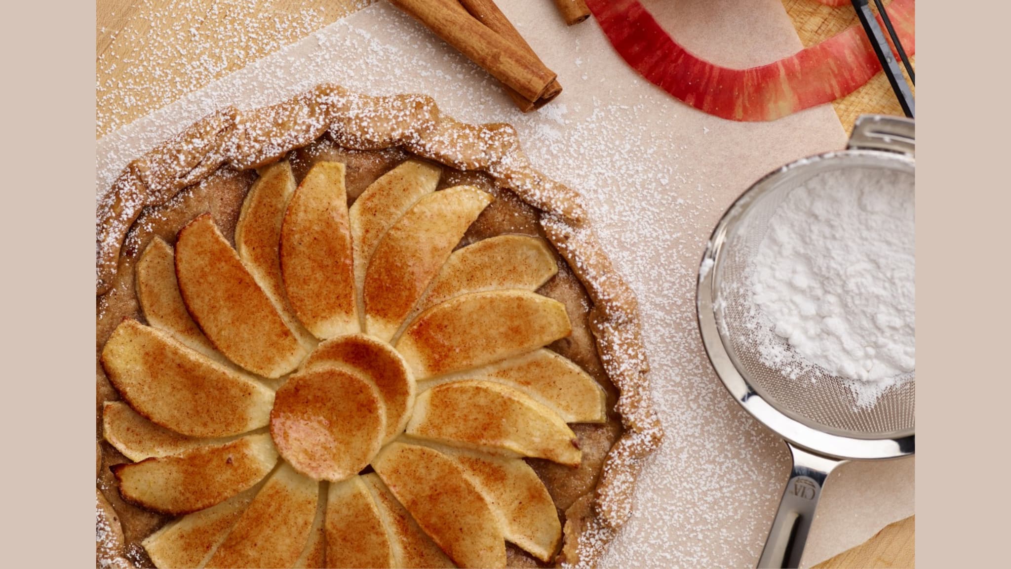 Rustic apple tart with powdered sugar dusting