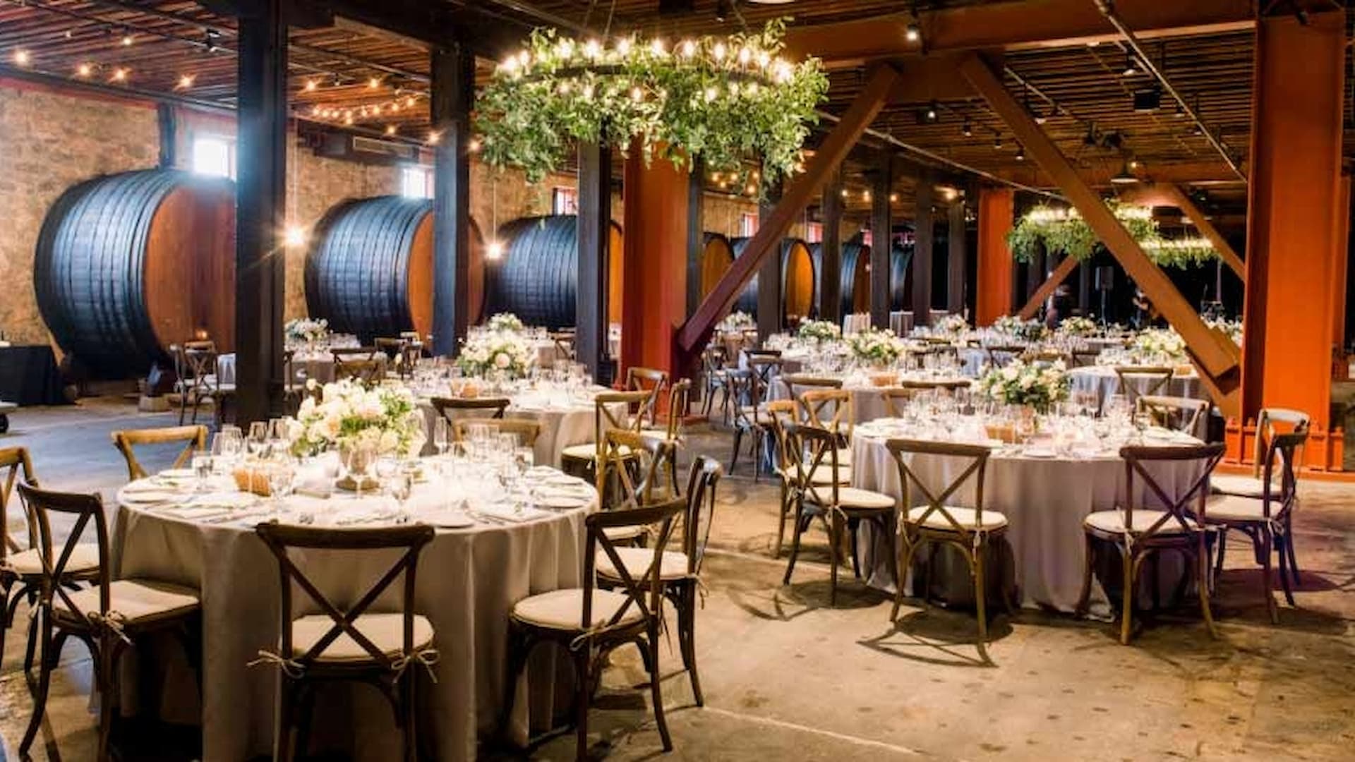 Elegant winery reception with barrels and string lights